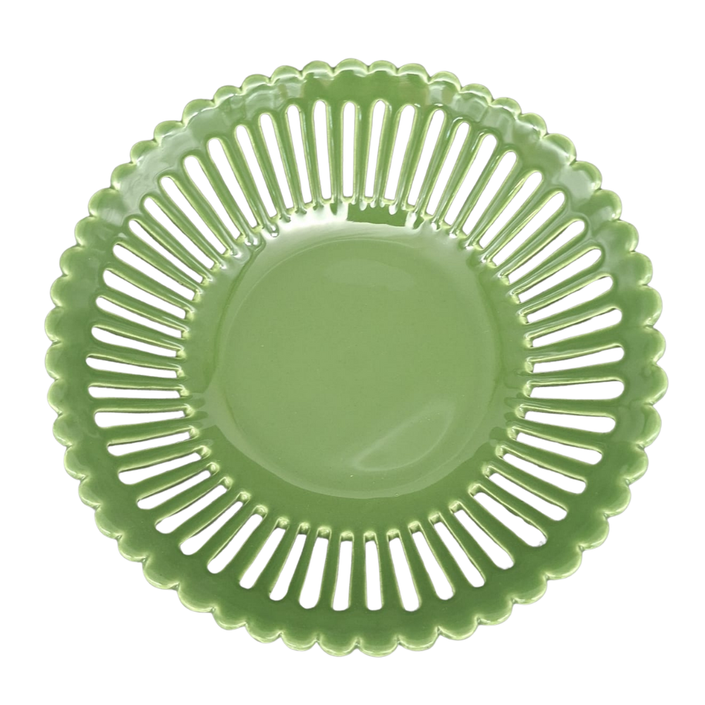 A leaf green ceramic basket with a scalloped rim and a series of vertical slits around the outer edge, shown from a top-down view on a white background.