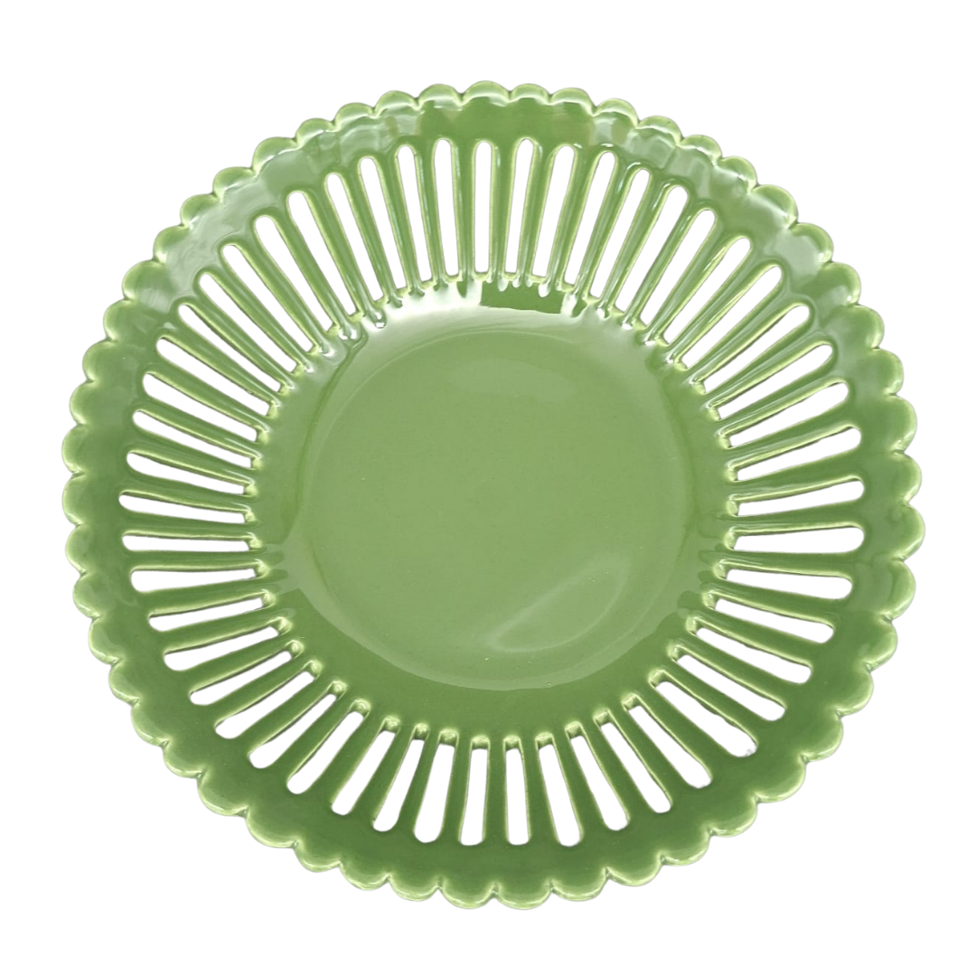 A leaf green ceramic basket with a scalloped rim and a series of vertical slits around the outer edge, shown from a top-down view on a white background.