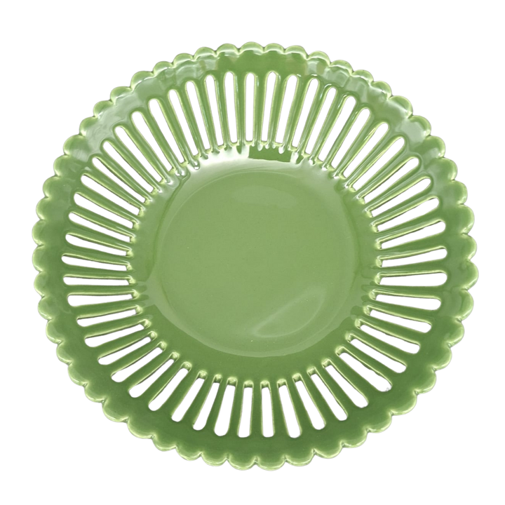 A leaf green ceramic basket with a scalloped rim and a series of vertical slits around the outer edge, shown from a top-down view on a white background.