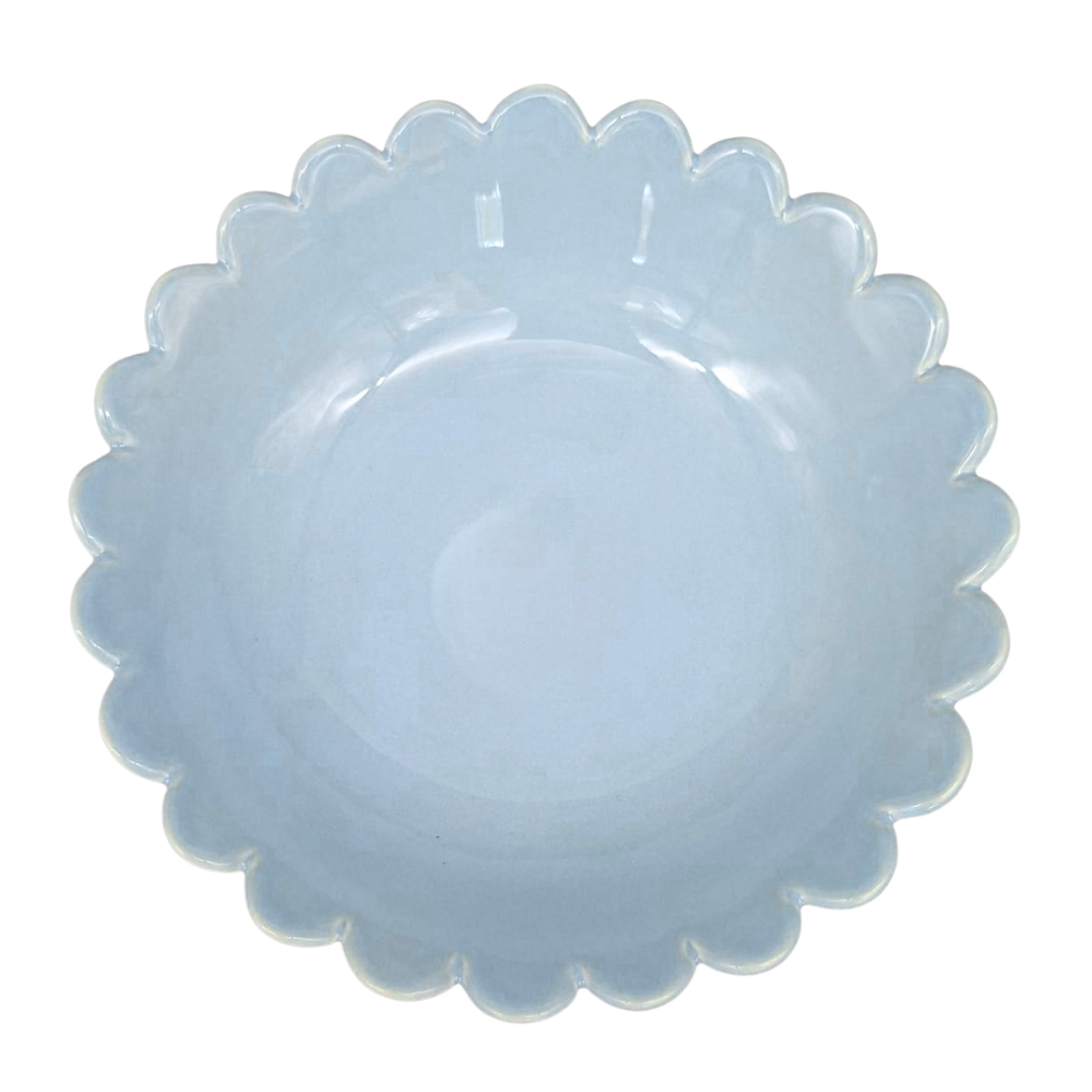 A scalloped-edge ceramic plate in a light blue glaze, photographed from directly above on a white background.