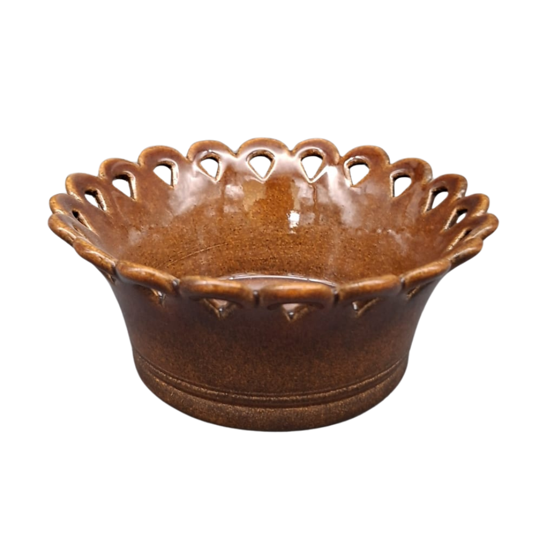 A brown ceramic bowl with a scalloped, decorative rim featuring cutout details, shown on a plain white background.