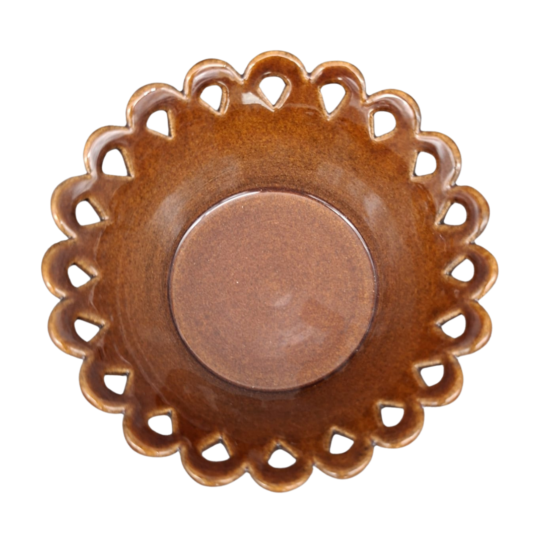 A round ceramic dish with a scalloped, lacy cutout rim and a smooth, glossy brown center, shown from a top-down perspective on a white background.