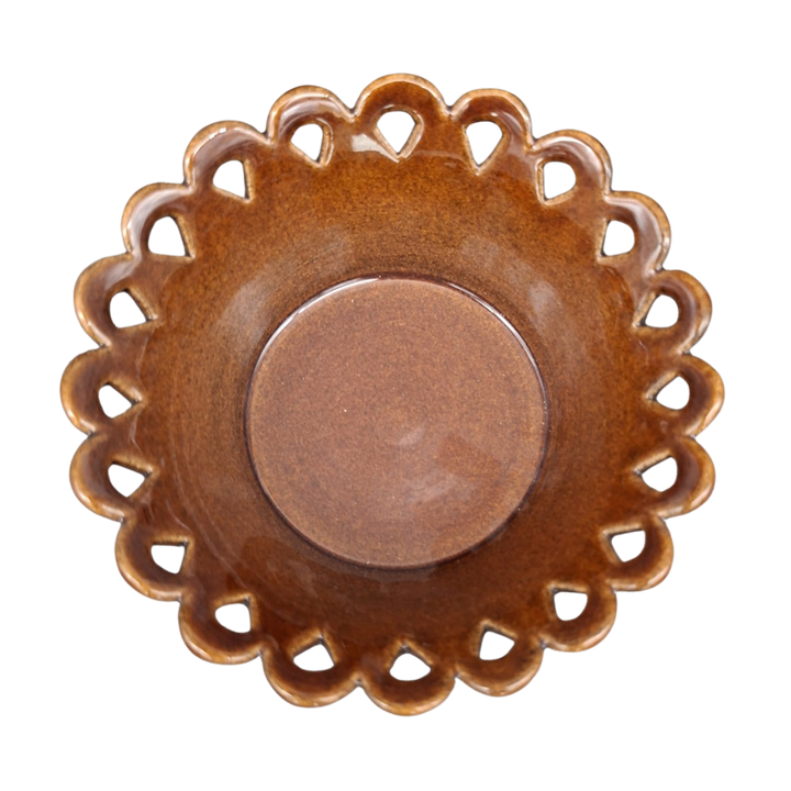 A round ceramic dish with a scalloped, lacy cutout rim and a smooth, glossy brown center, shown from a top-down perspective on a white background.