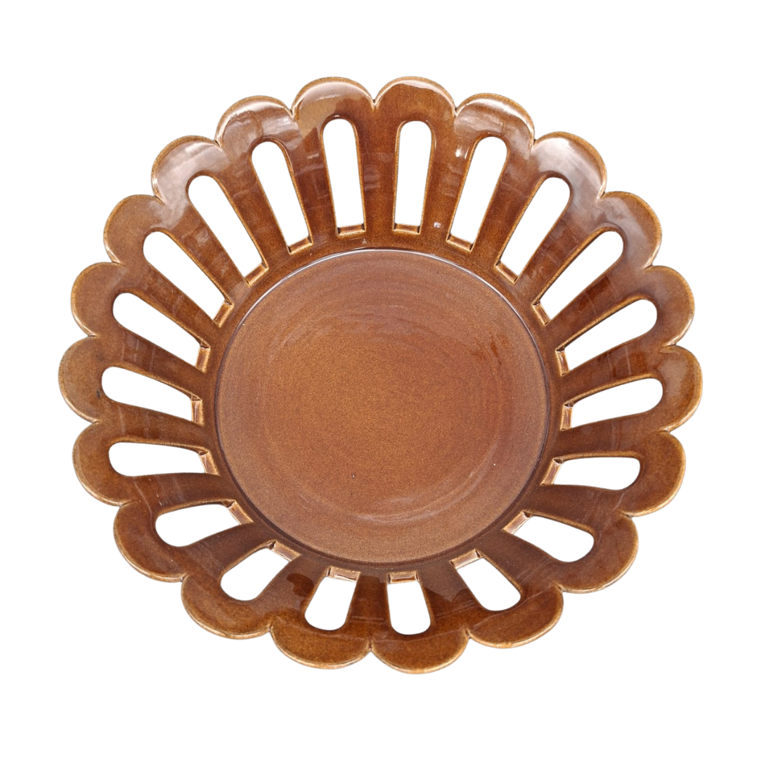 A round ceramic basket with a scalloped edge and cutout slots, shown from a top-down view on a white background.