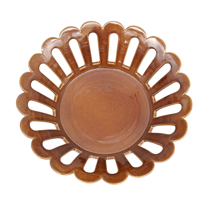 A round ceramic basket with a scalloped edge and cutout slots, shown from a top-down view on a white background.
