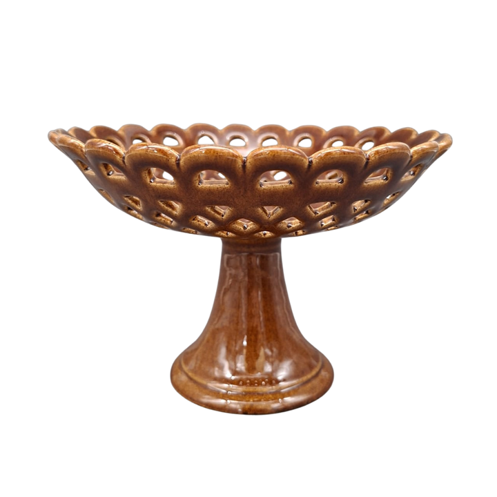A brown ceramic pedestal bowl with a scalloped, openwork lattice rim and a flared base, shown on a plain white background.