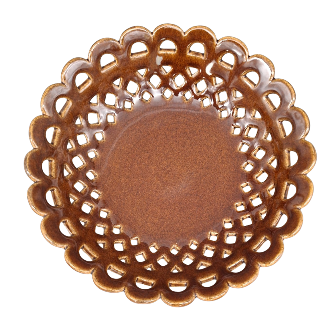 A round ceramic plate with a scalloped, openwork lattice edge and a smooth, glossy brown center, shown from a top-down perspective on a white background.