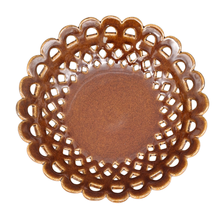 A round ceramic plate with a scalloped, openwork lattice edge and a smooth, glossy brown center, shown from a top-down perspective on a white background.