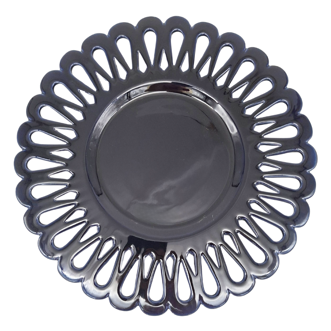 A round scalloped openwork plate with a navy blue glaze, isolated on a white background.