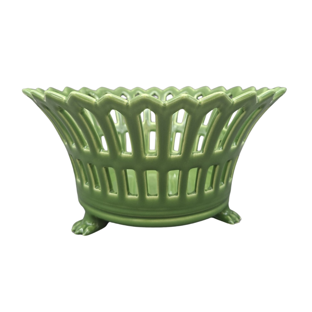 A green ceramic Restauration basket with a scalloped rim, vertical slotted body, and three claw feet, shown on a plain white background.