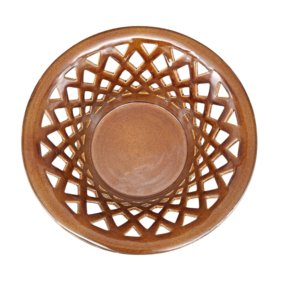 A round ceramic bowl with a brown lattice pattern on the outer rim, photographed from directly above on a white background.