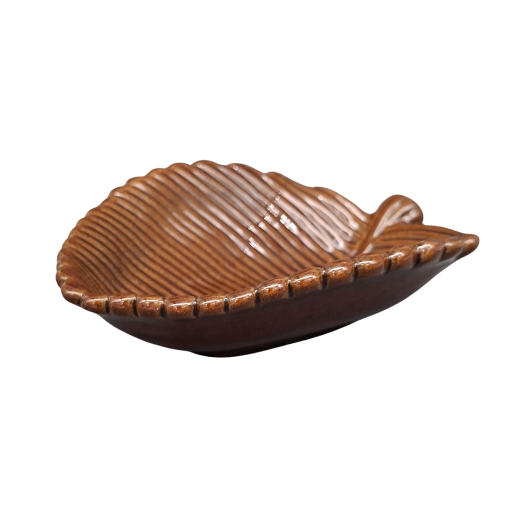 A leaf-shaped ceramic dish with a glossy brown glaze and textured ridges, shown on a plain white background.