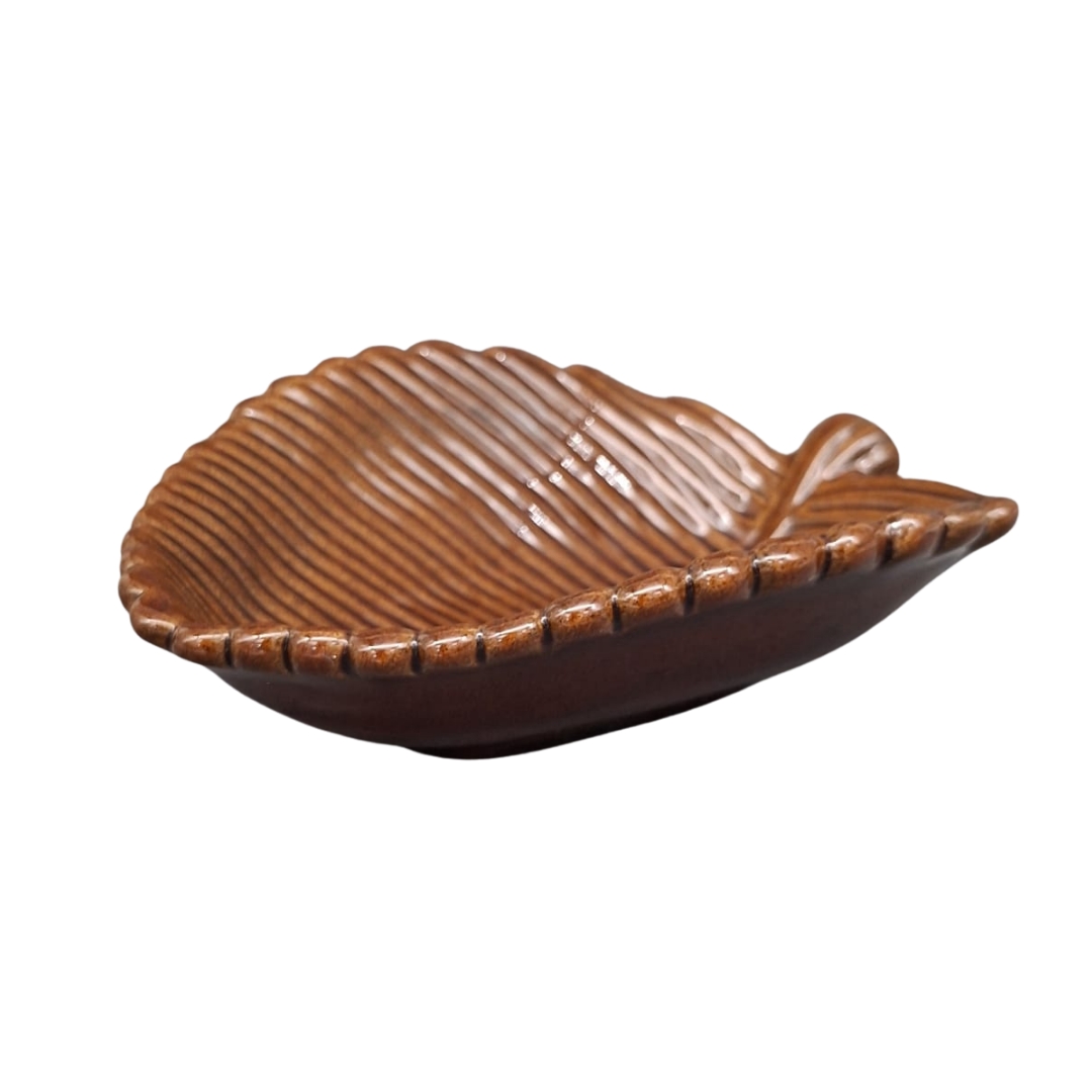 A leaf-shaped ceramic dish with a glossy brown glaze and textured ridges, shown on a plain white background.
