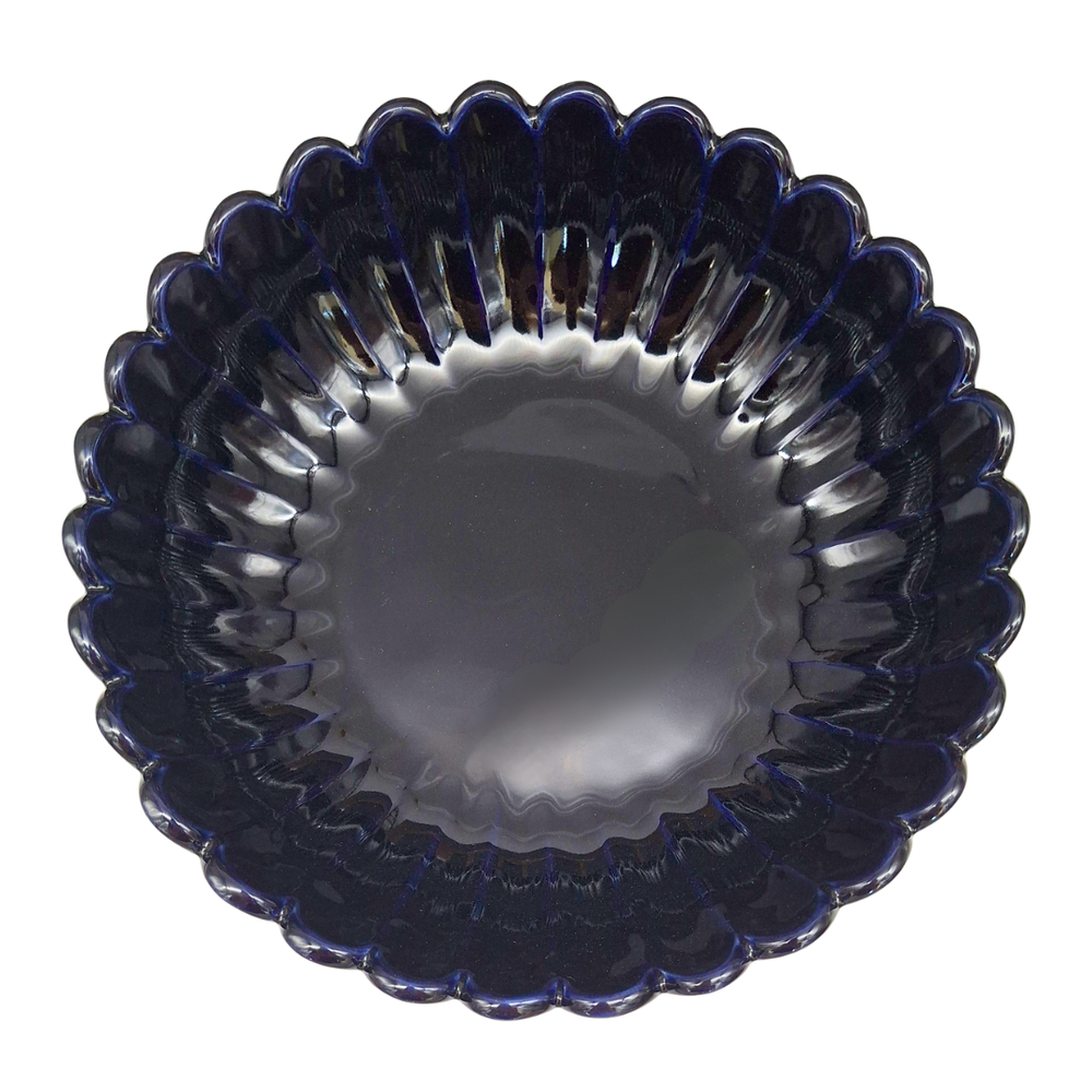 A scalloped glass bowl with a deep navy blue color and a ribbed, textured rim, shown from a top-down view on a white background.