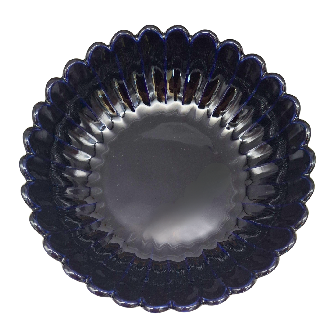 A scalloped glass bowl with a deep navy blue color and a ribbed, textured rim, shown from a top-down view on a white background.