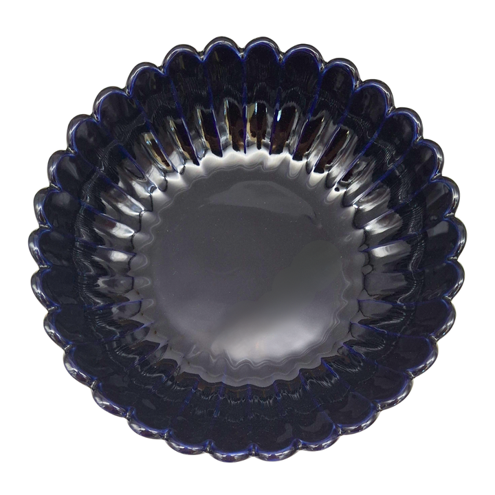 A scalloped glass bowl with a deep navy blue color and a ribbed, textured rim, shown from a top-down view on a white background.
