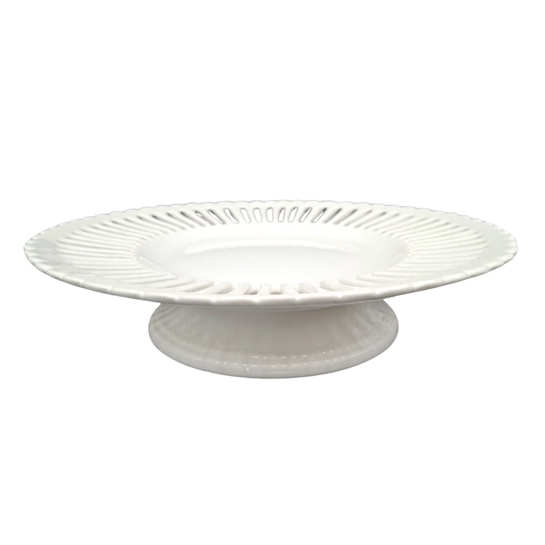 A white ceramic large pedestal serving plate with a fluted rim and a ribbed base, shown against a plain white background.