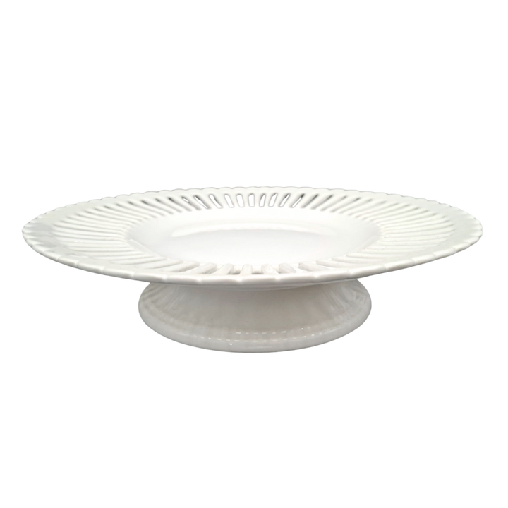 A white ceramic large pedestal serving plate with a fluted rim and a ribbed base, shown against a plain white background.