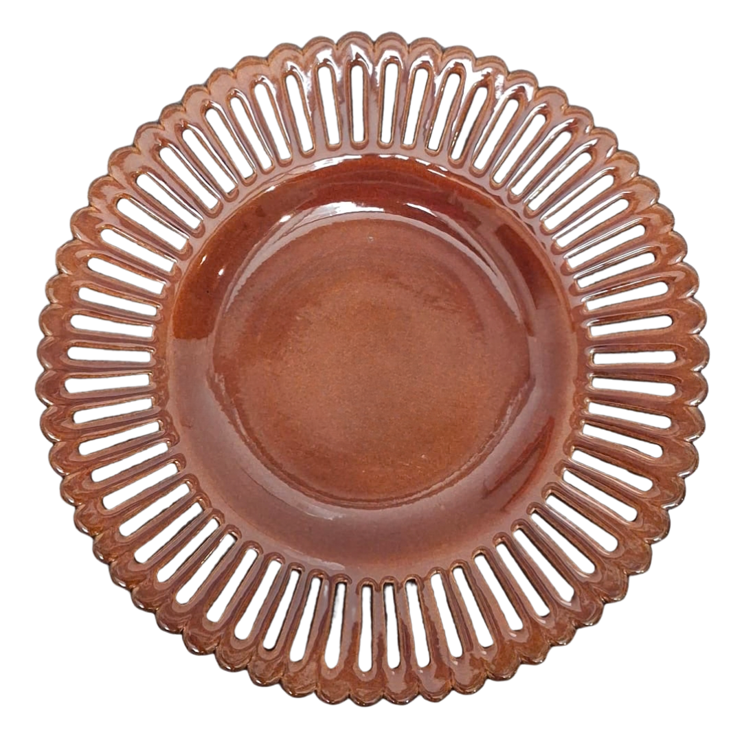 A round brown plate with a scalloped, openwork rim, photographed from directly above on a white background.