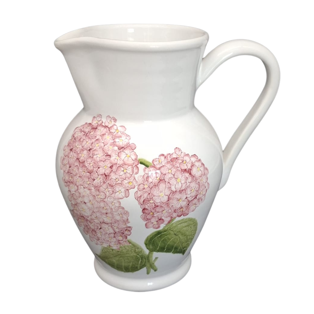 A white ceramic pitcher decorated with a detailed hand painted botanical motif of pink hydrangea flowers and green leaves, shown against a plain white background.