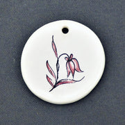Earthenware Disc ornament with a hand painted flower motif