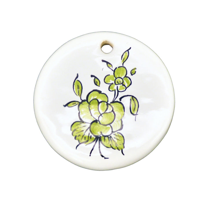 Disc ornament with a hand painted green flower
